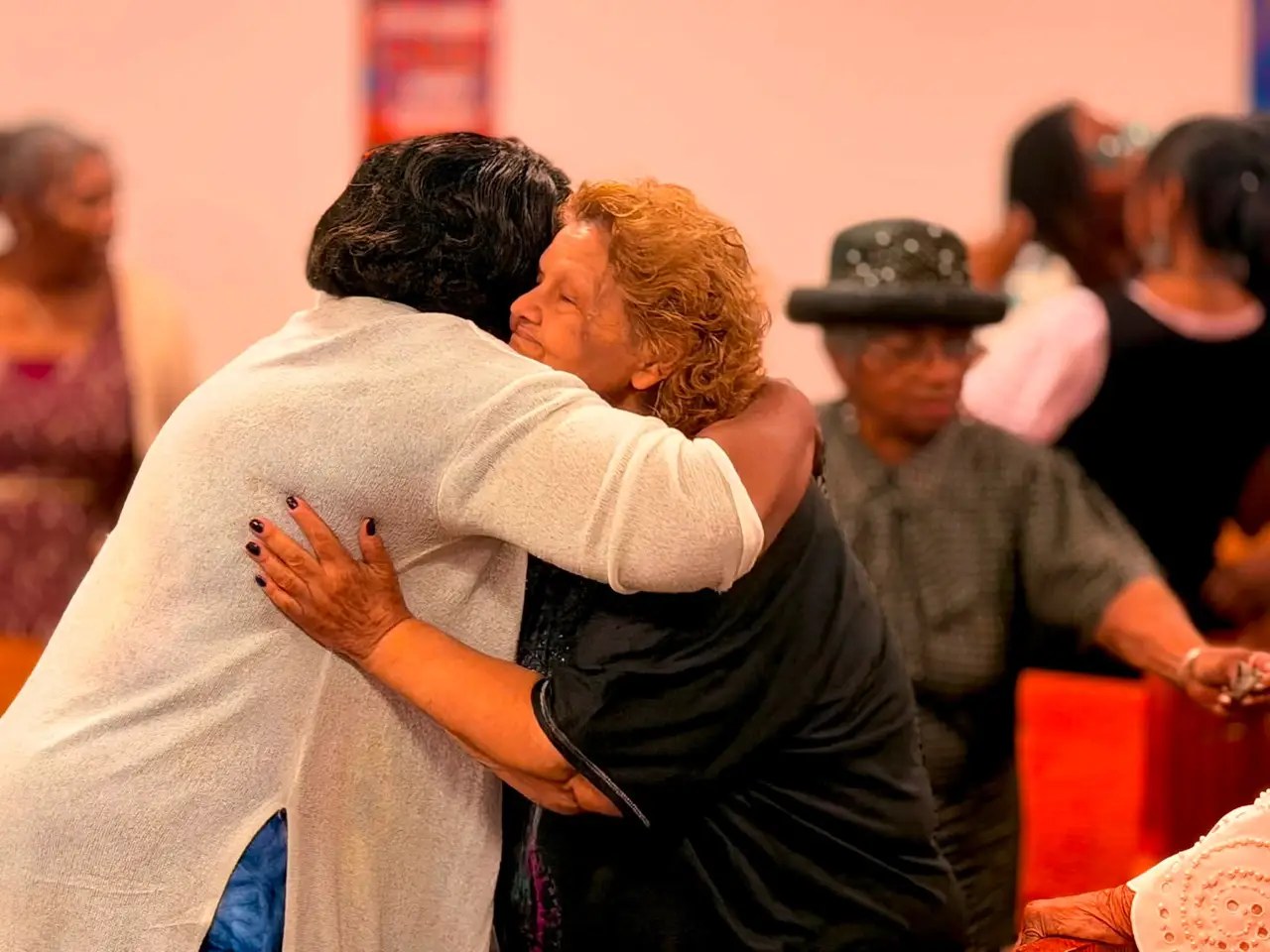 Church members embracing.