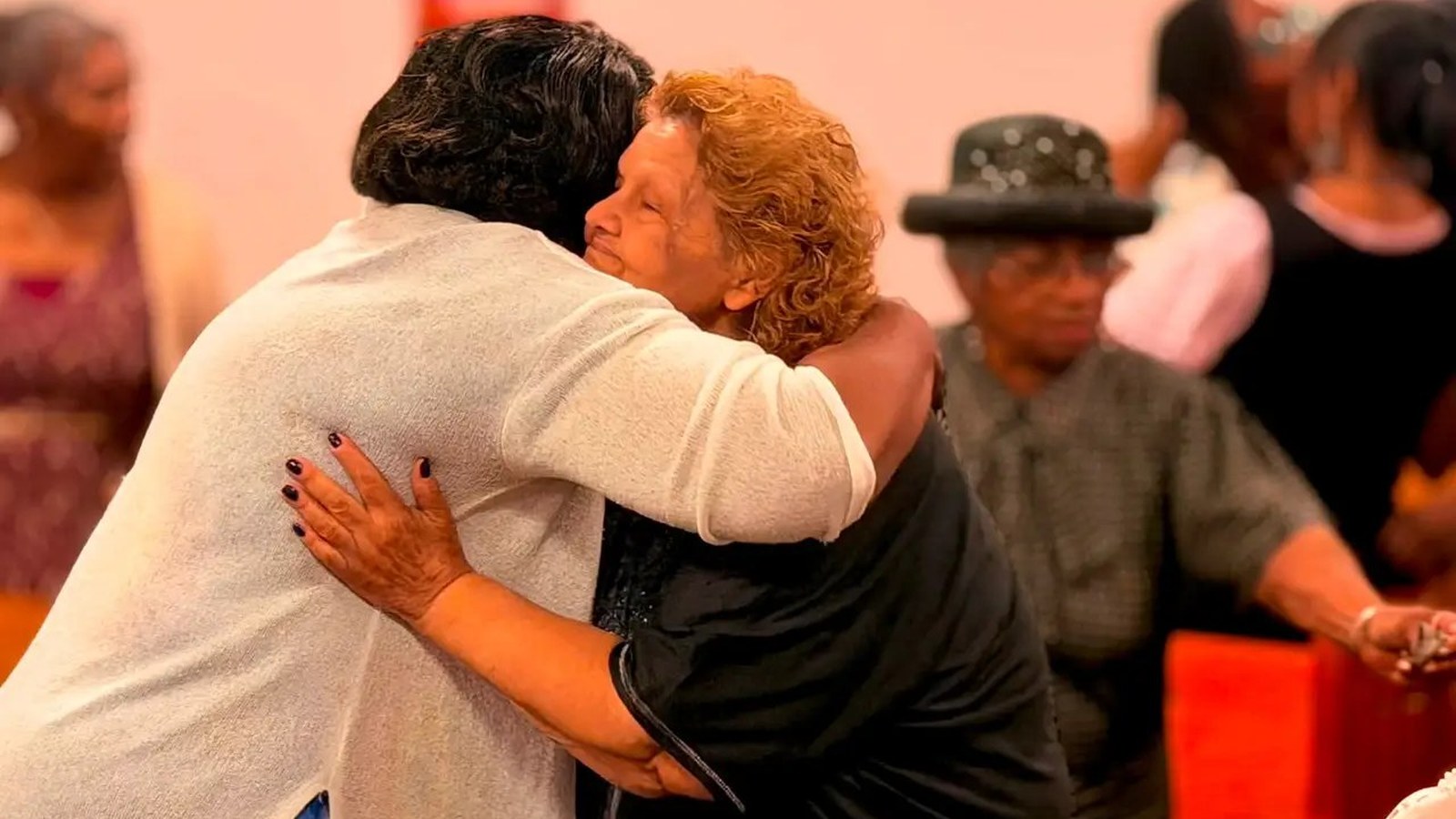 Unity Temple members sharing an embrace in fellowship.